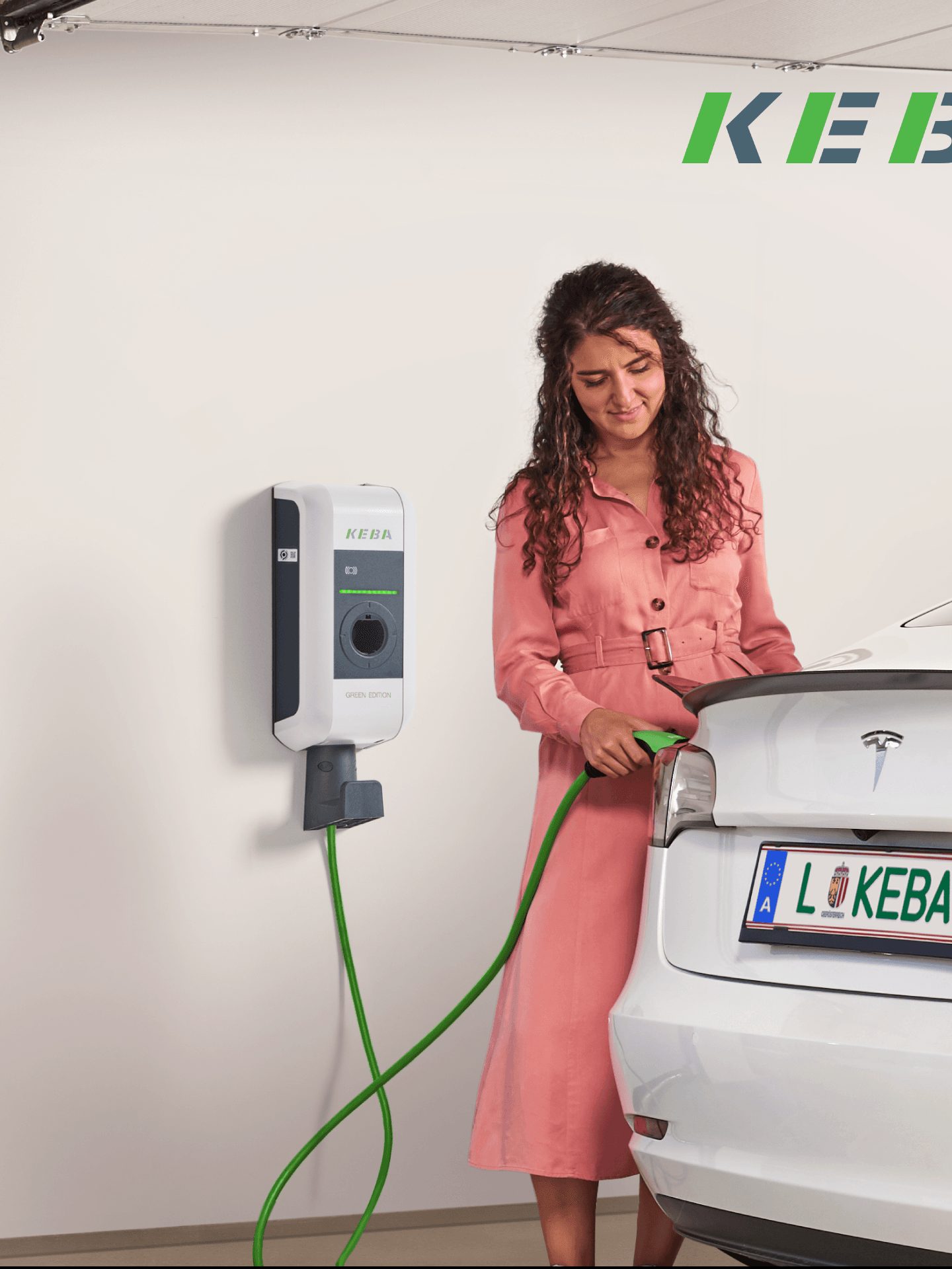 Frau lädt Tesla an KEBA Wallbox
