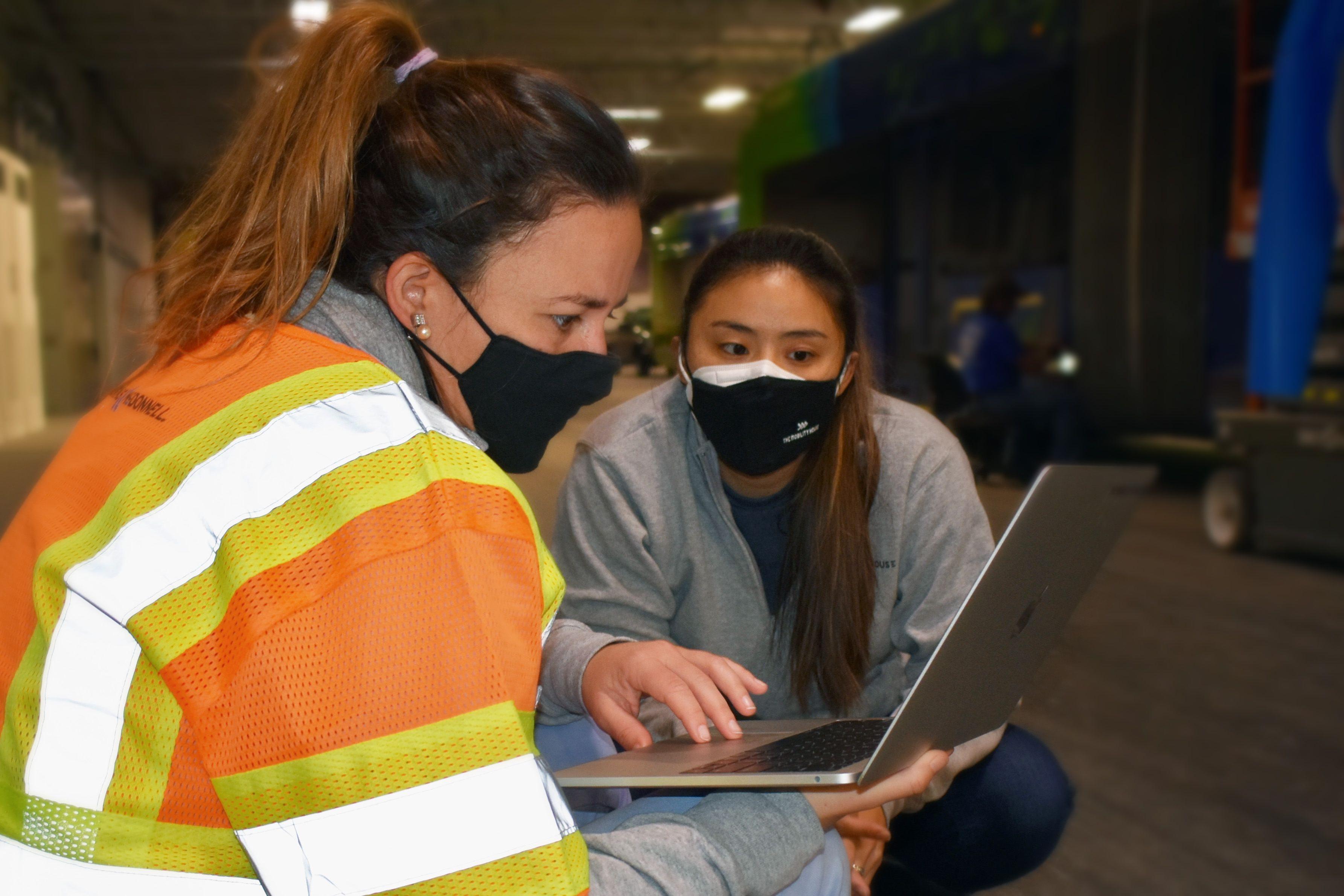 Two colleagues at work in a bus depot